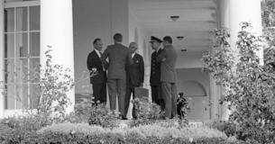 President Kennedy and advisors on White House colonnade
