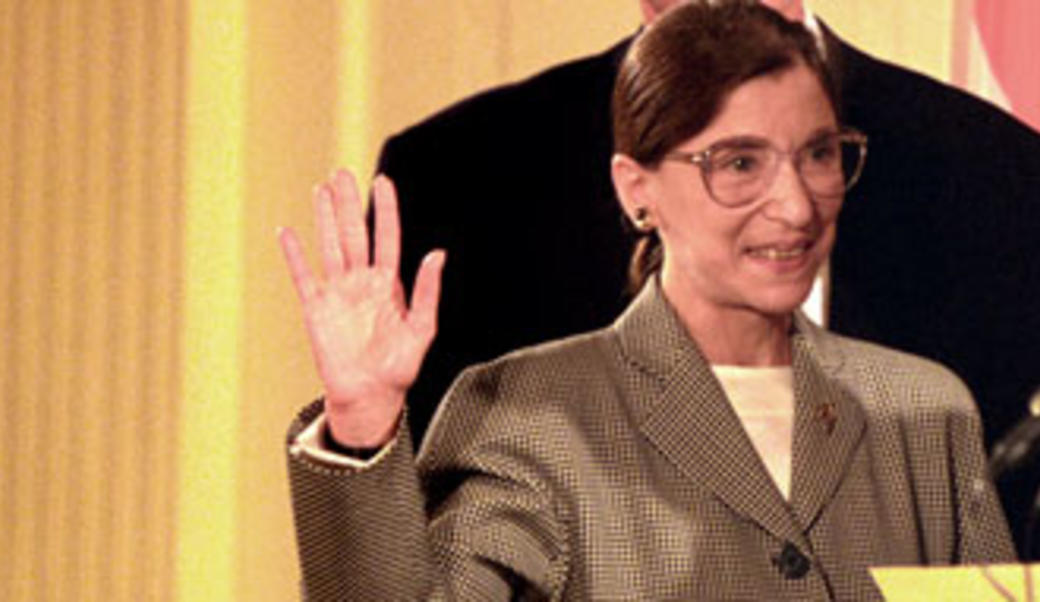Ruth Bader Ginsburg with hand raised
