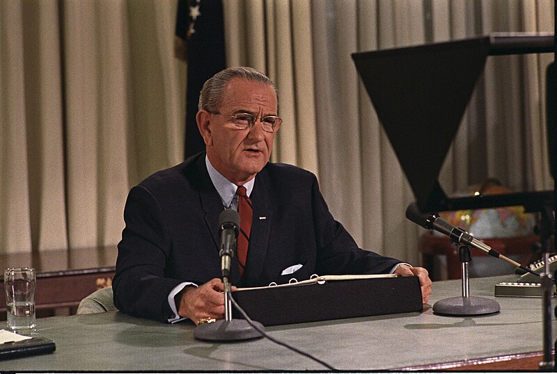 LBJ sitting at a desk
