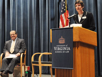 Antonin Scalia sits while he is introduced by Barbara Perry in 2010