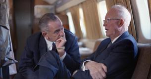 President Lyndon Johnson talks to former President Dwight Eisenhower on a plane