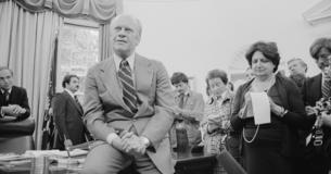 President Ford speaks with reporters in the Oval Office