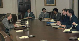 President Jimmy Carter sitting across from White House aides in a budget meeting.