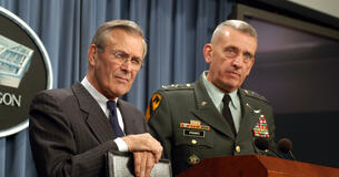 General Tommy Franks and Secretary of Defense Donald Rumsfeld answering questions at a press conference.