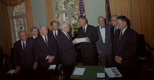 Members of the Warren Commission hand LBJ the report