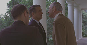 President Johnson giving the "Johnson treatment" (leaning in close) to Sargent Shriver