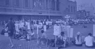 African American and white supporters of the Mississippi Freedom Democratic Party holding signs in front of the convention hall at the 1964 Democratic National Convention, Atlantic City, New Jersey
