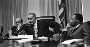 LBJ and Martin Luther King Jr. sitting at a table during a meeting