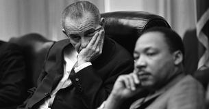 LBJ and Martin Luther King Jr. sitting at a table during a meeting
