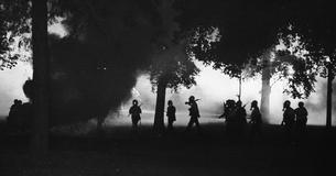 National guard troops walking amongst tear gas in Chicago, 1968