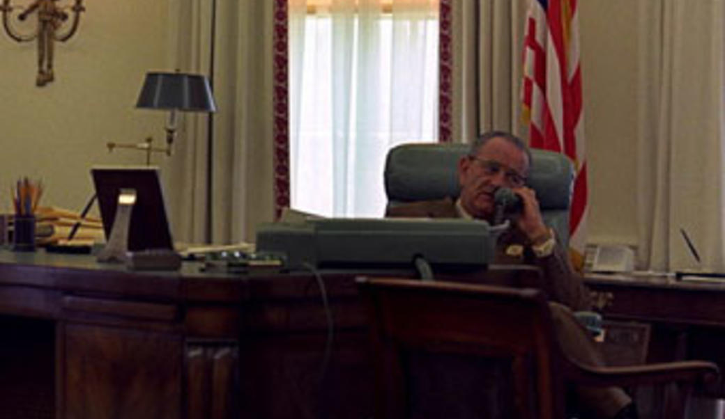 Lyndon Johnson on the phone sitting behind his desk
