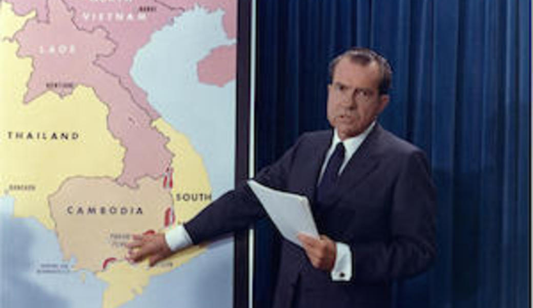 Richard Nixon pointing at map of Southeast Asia
