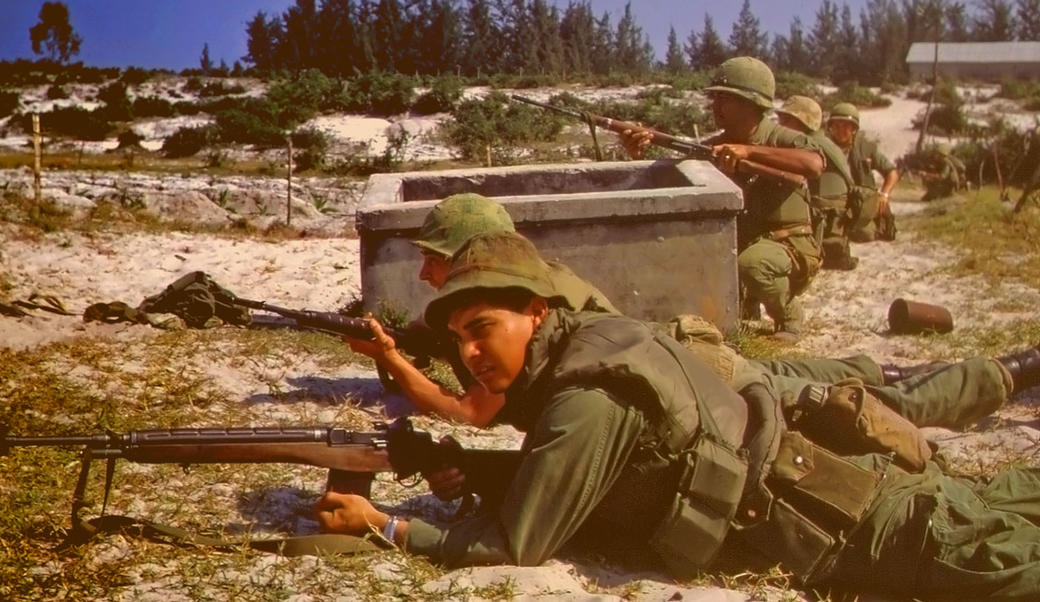 Soldiers aiming rifles laying on ground