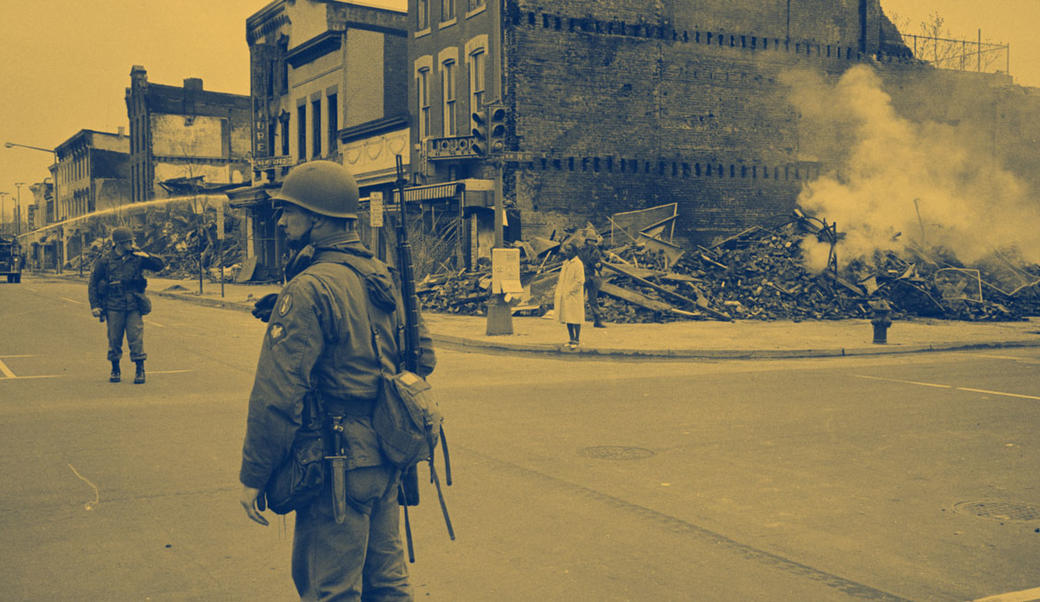 burnt out building with soldier in front