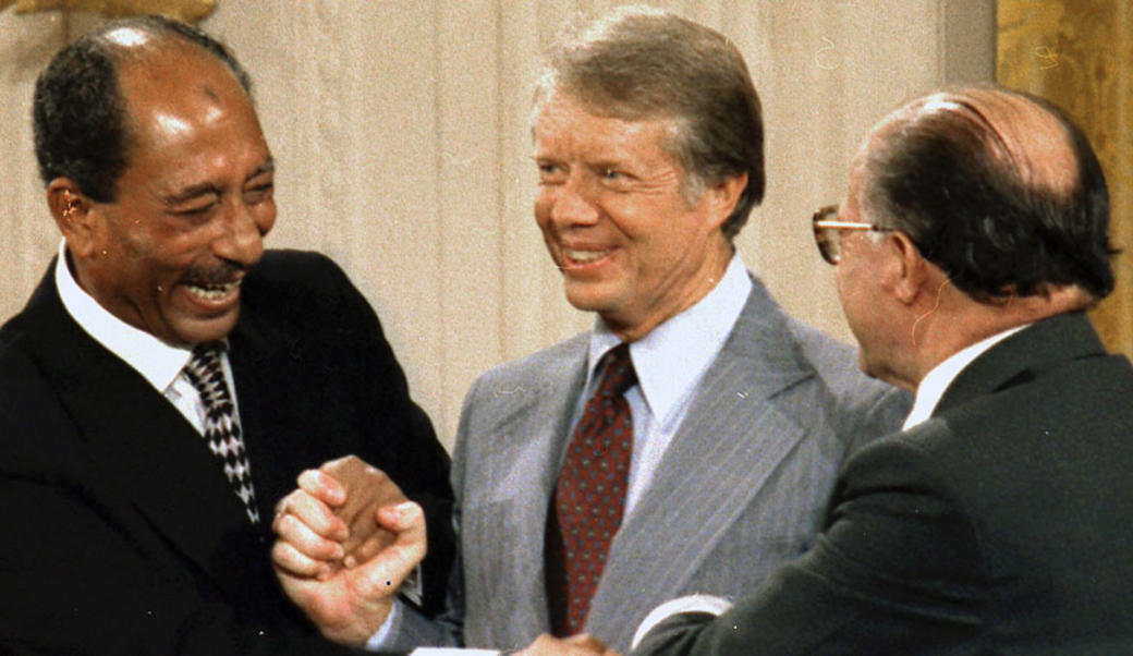 Anwar Sadat, President Carter, and Menachem Begin sign Camp David Accords