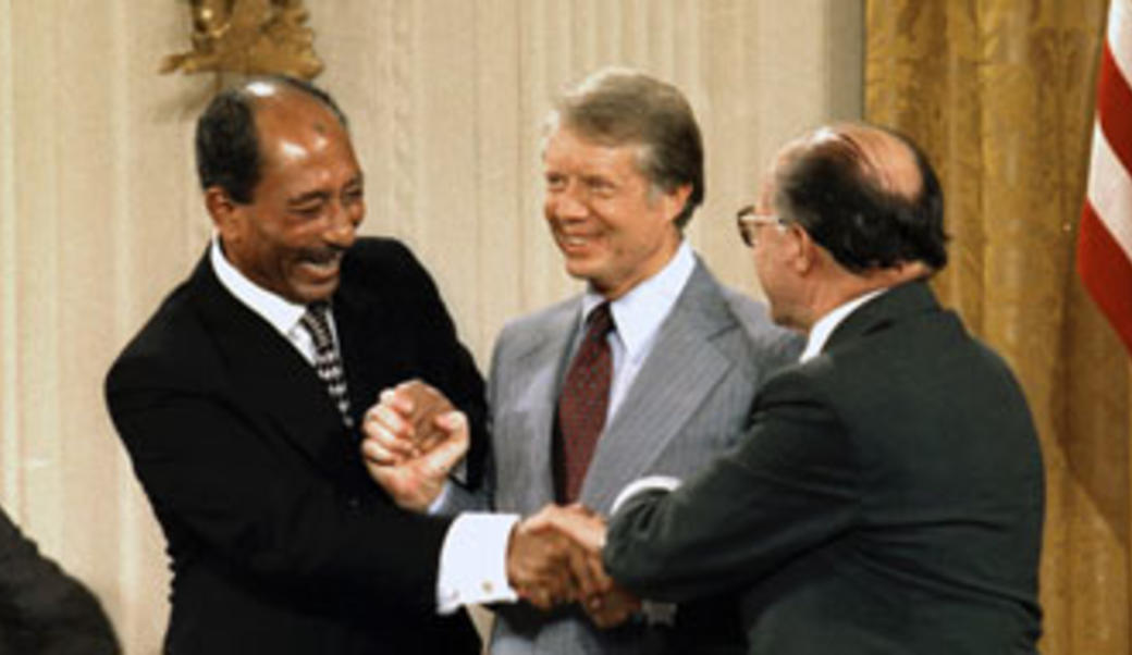 Anwar Sadat, President Carter, and Menachem Begin sign Camp David Accords