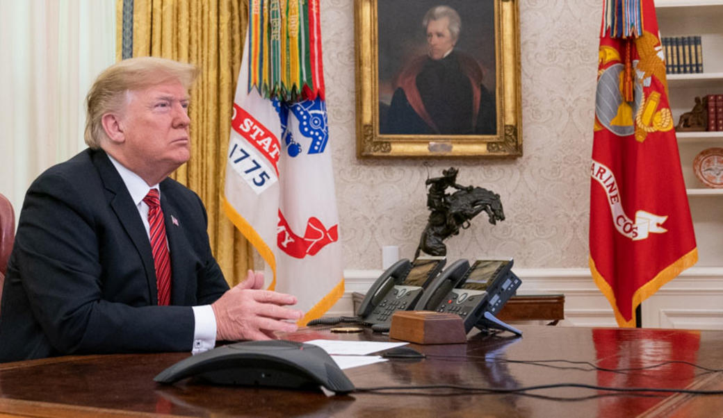 President Trump sits in the Oval Office