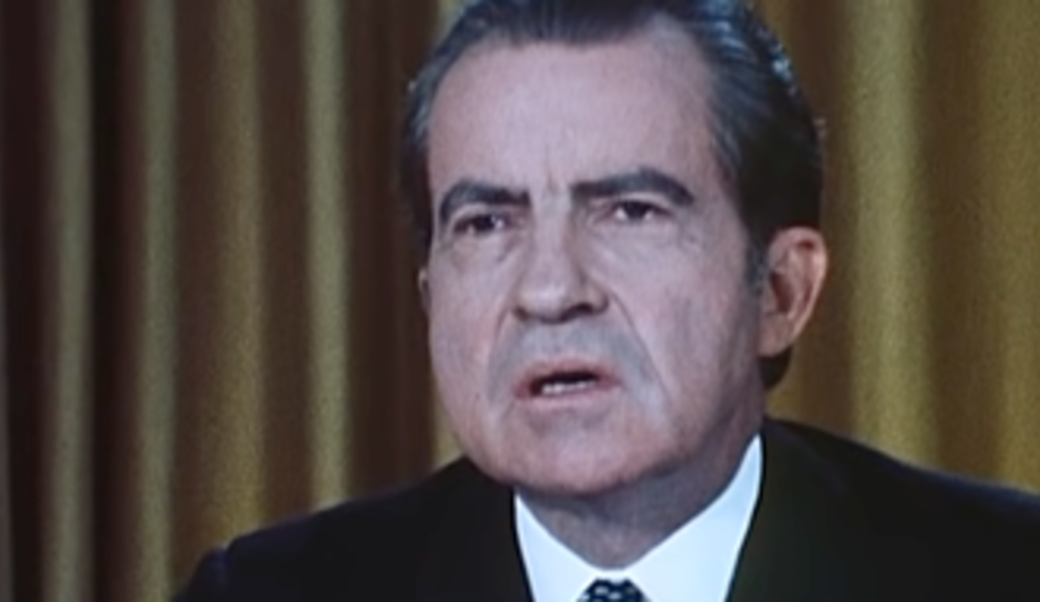 President Nixon holding paper