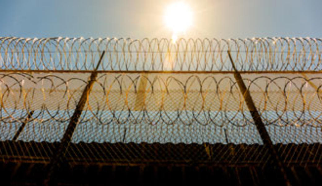 Wall topped with barbed wire