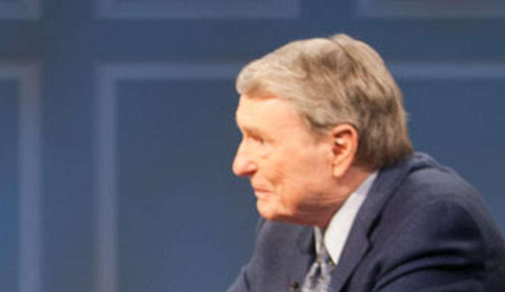 Jim Lehrer in profile against blue
