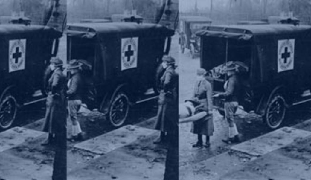 Nurses loading soldier into ambulance in 1918