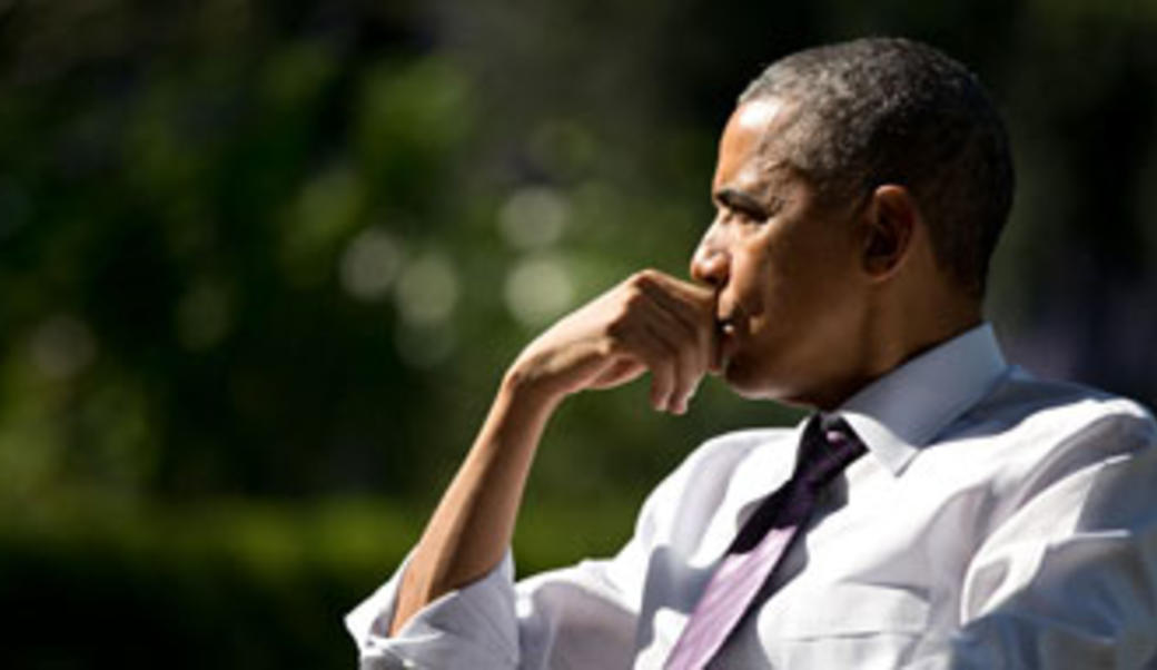 President Obama in profile with chin on hand