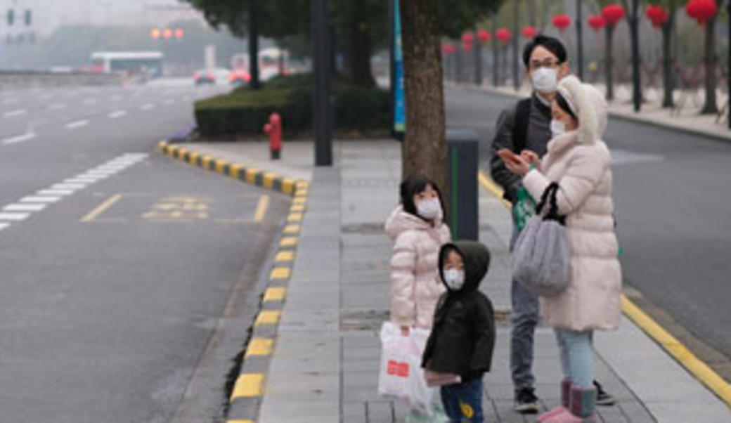 A family in China wearing masks during the COVID-19 pandemic