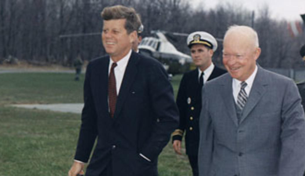 John F. Kennedy walks beside Dwight Eisenhower