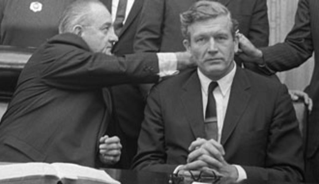Lyndon Johnson reaching out to shake a hand