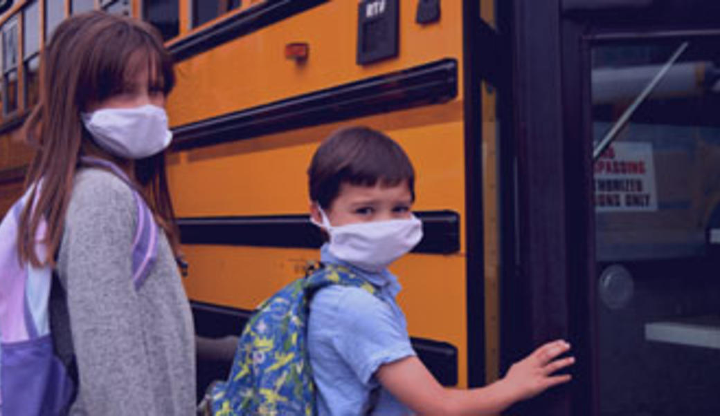 kids in masks getting on schools
