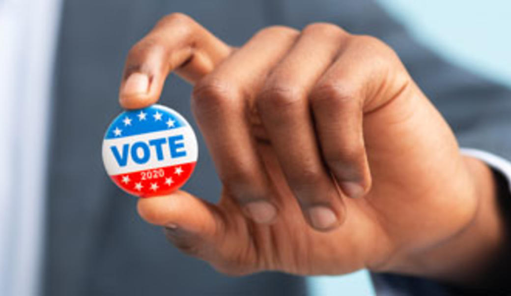 hand holding up "vote" button