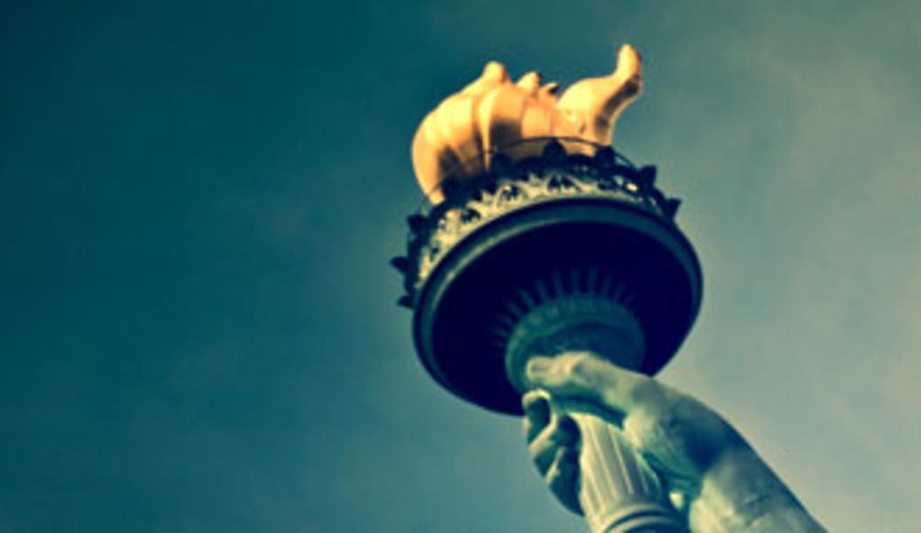 Statue of Liberty torch isolated against blue sky