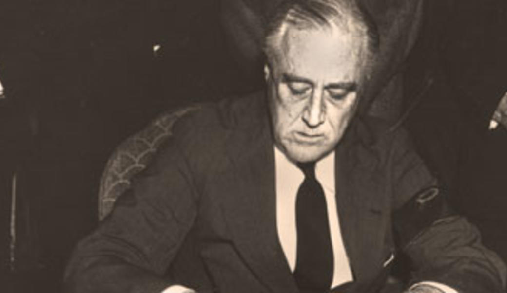 Franklin Roosevelt signing a document