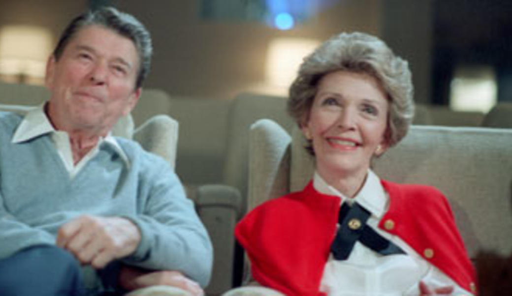 Ronald and Nancy Reagan watching a movie