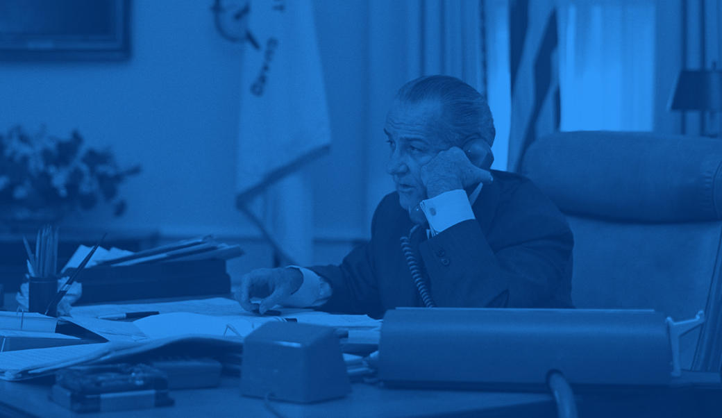 LBJ on the telephone sitting at his desk