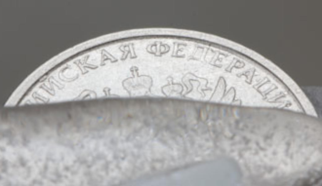 Russian coin frozen in ice to represent frozen assets