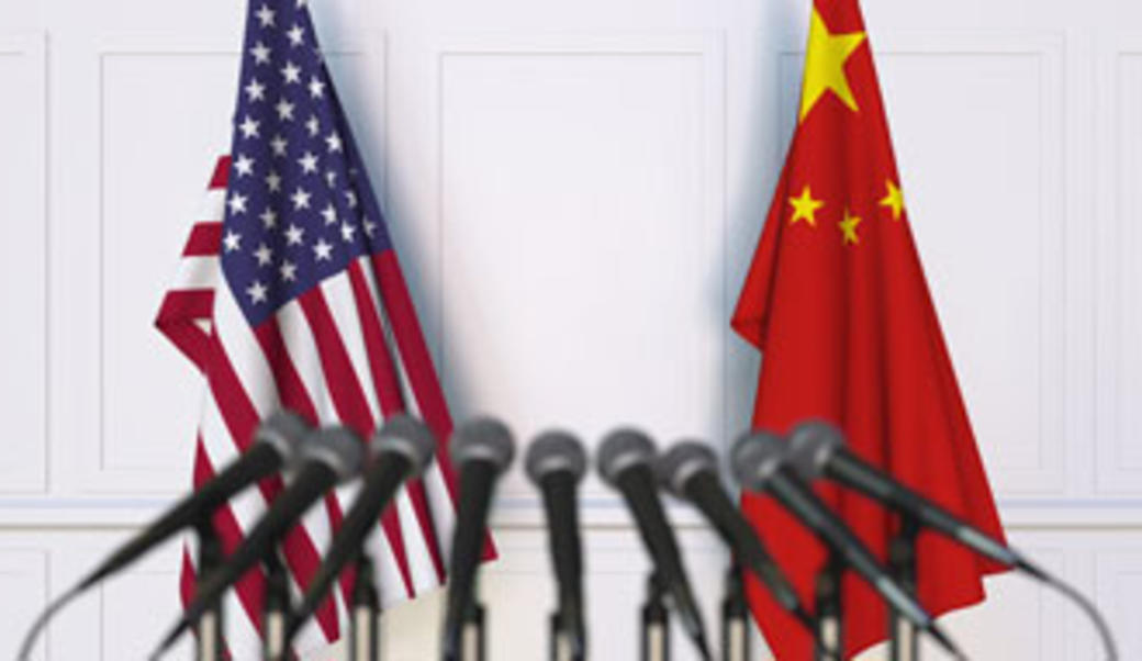 Microphones in front of the Chinese and American flags