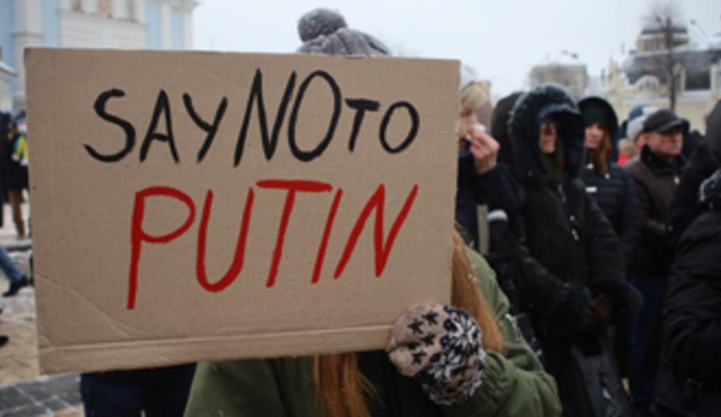 Person holding sign reading "Say no to Putin"