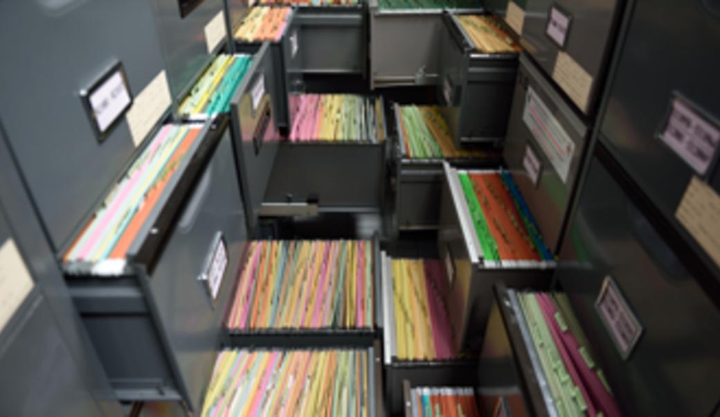 open filing cabinets showing colored file folders
