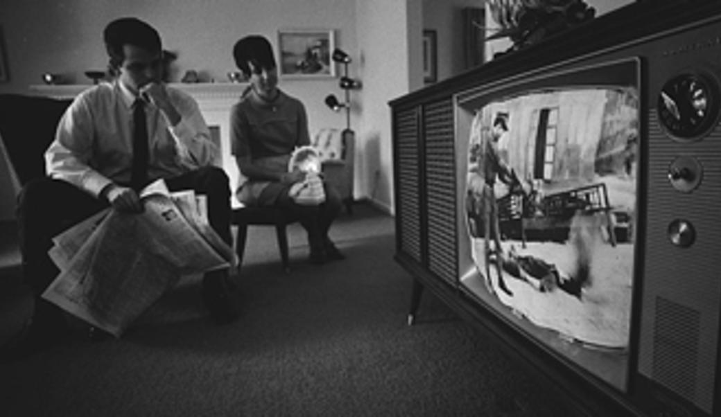An American couple watches footage of the Vietnam War on their television on January 1, 1968.