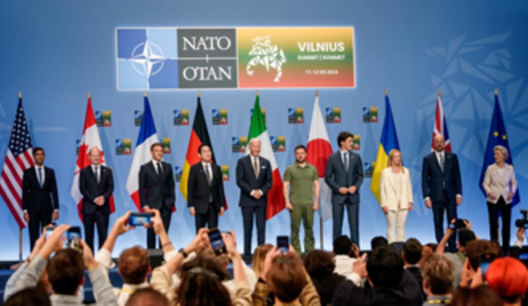 G7 leaders stand on stage to announce a Joint Declaration of Support to Ukraine during the 2023 NATO summit.