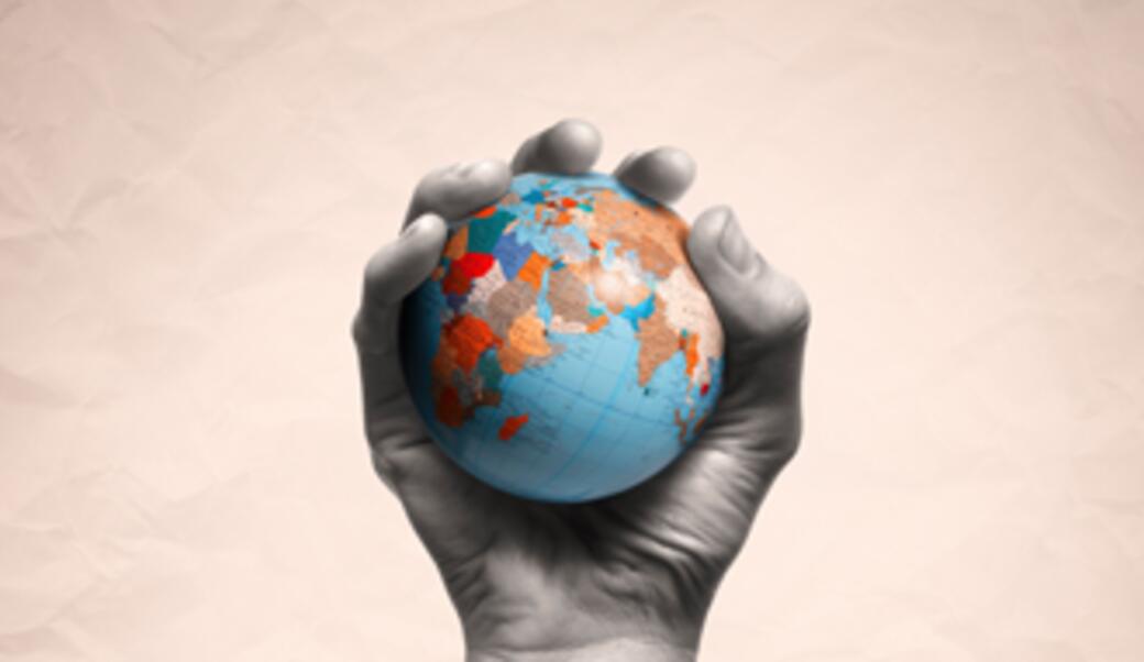 hand holding a globe