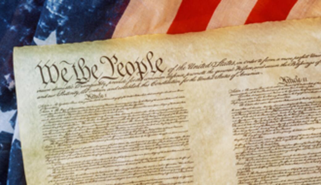 image of the Constitution in front of American flag