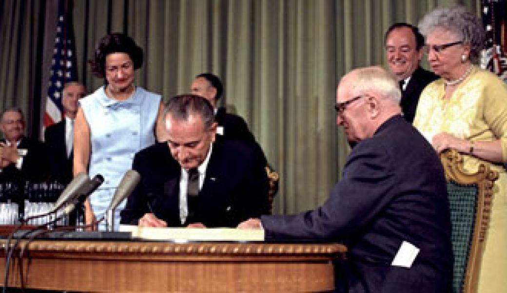 Lyndon Johnson signing a bill