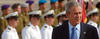 George W. Bush in front of naval officers