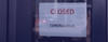 Shopkeeper posts a sign that a business is closed due to coronavirus