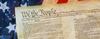 image of the Constitution in front of American flag